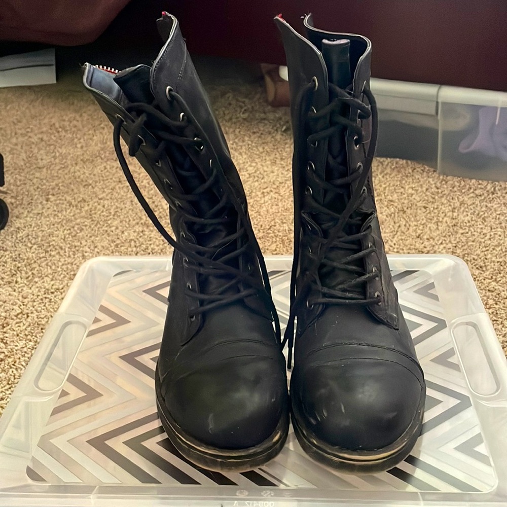 Black combat boots. Zip up in the back and tie in the front.